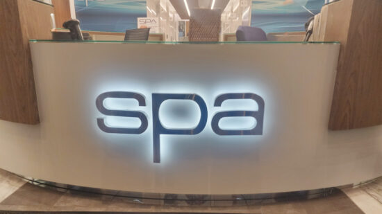 Custom interior signage on the front desk of the office for SPA, created by Distinct Sign Solutions (DSS).