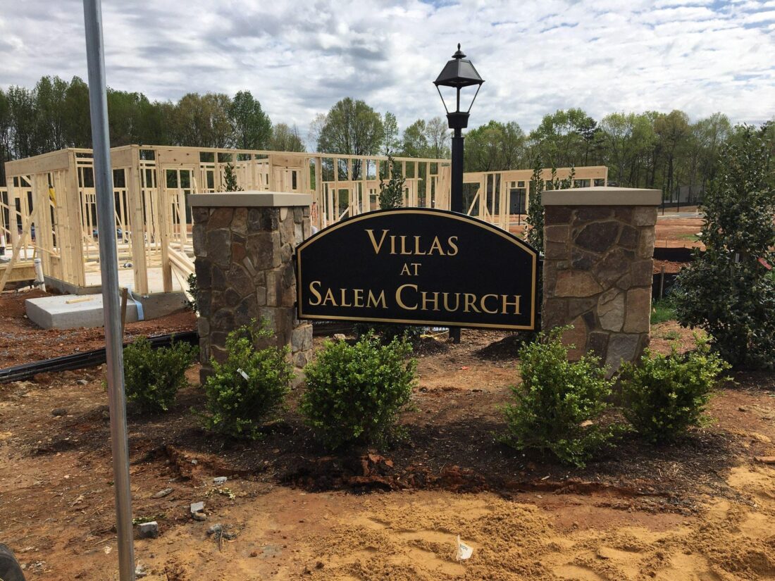 alt="Photo of black and gold routed HDU monument sign for subdivision entrance in Fredericksburg, Virginia"