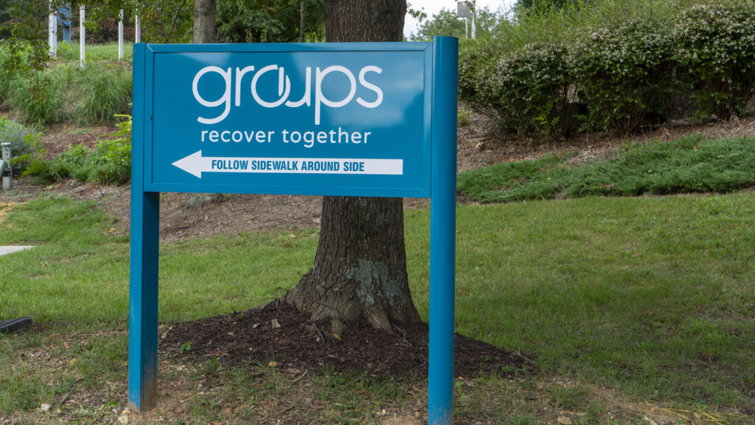 A blue exterior wayfinding sign for Groups - Recover Together in Fredericksburg, VA, created by Distinct Sign Solutions. An example of an effective healthcare sign.