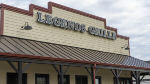 alt="Photo of newly installed black and white channel letter restaurant sign mounted to wall in Spotyslvania, Virginia"