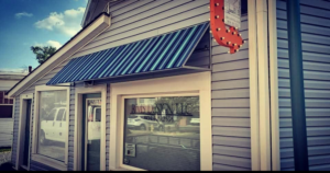 alt="Photo of blue and teal striped awning for design company in Colonial Beach, Virginia"