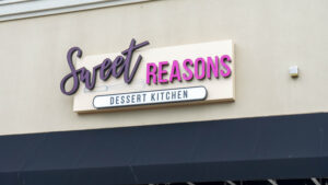 alt="Photo of newly installed Sweet Reasons channel letter sign mounted to wall in Central Park, Fredericksburg, Virginia"