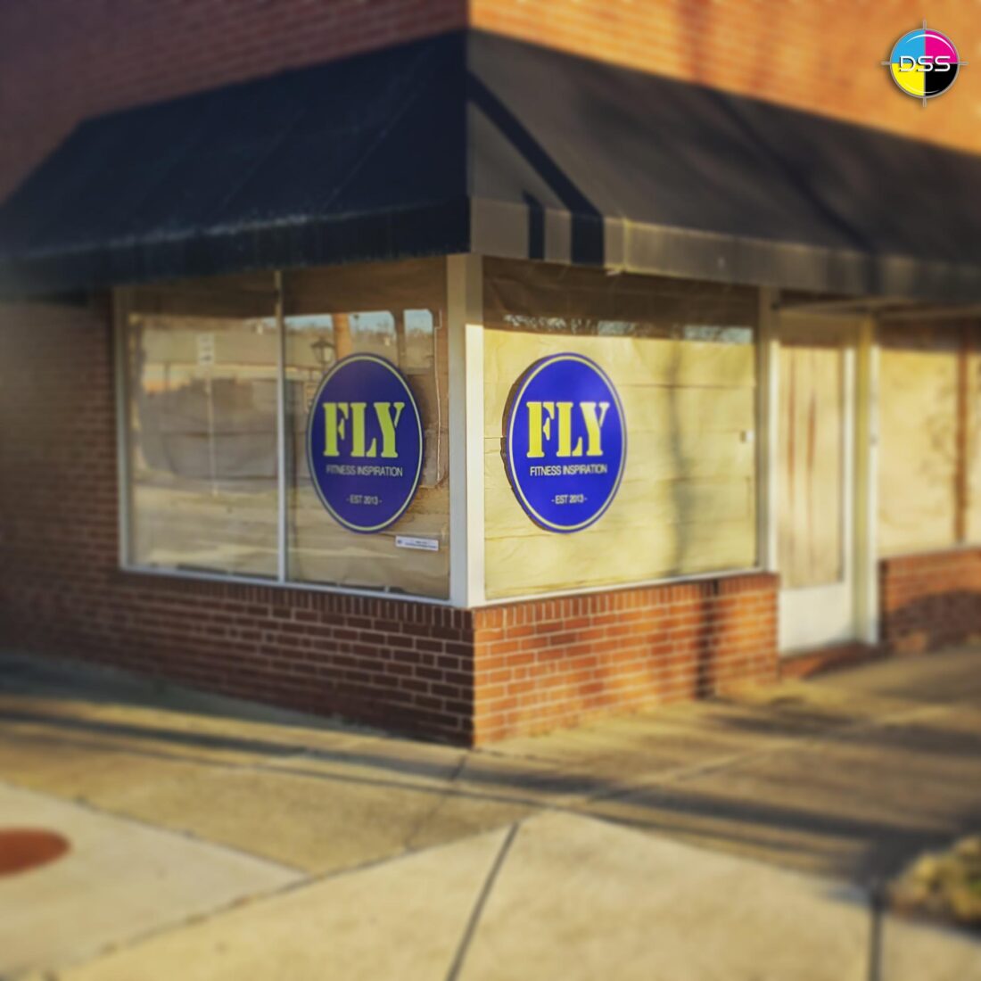 alt="Photo of blue and yellow vibrant circle graphics on windows located in Fredericksburg, Virginia"