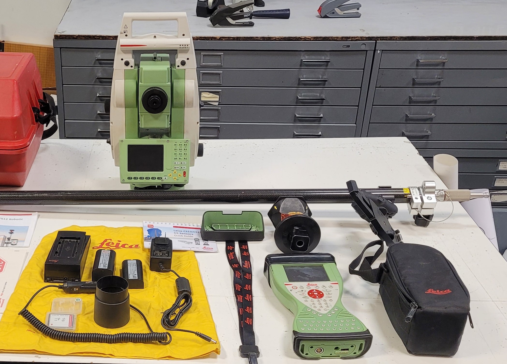 Image of various surveying equipment supplies on table