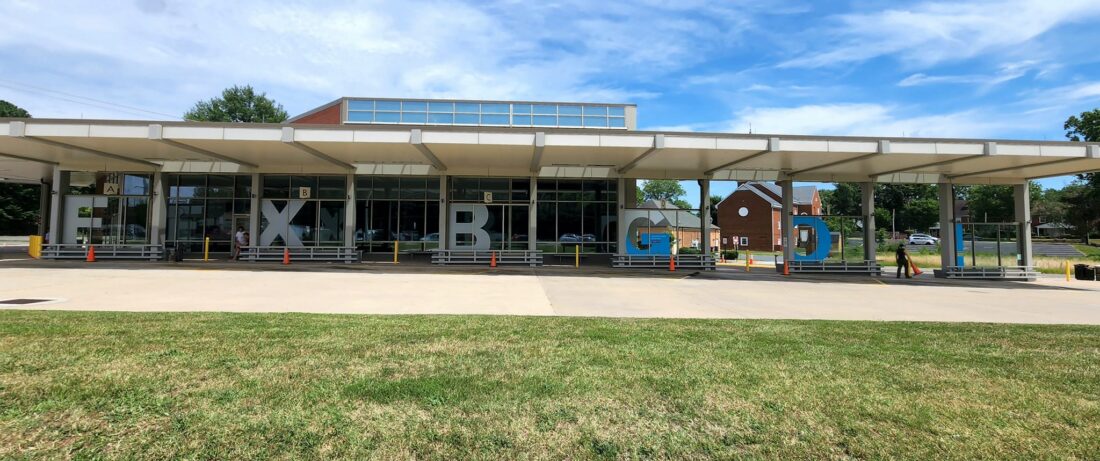 alt="Photo of bright blue and frosted vinyl graphics for bus station station located in Fredericksburg, Virginia"