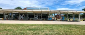 alt="Photo of bright blue and frosted vinyl graphics for bus station station located in Fredericksburg, Virginia"