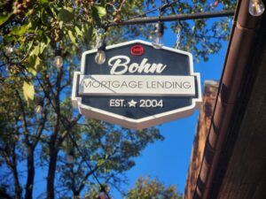 A hanging blade sign for Bohn Mortgage showcasing vibrant 3D elements, located in Fredericksburg, VA, created by Distinct Sign Solutions.