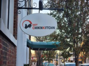 alt="Photo of hanging blade sign located in Downtown Fredericksburg, Virginia"