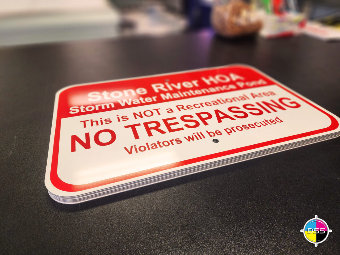 alt="Photo of recently completed custom red and white no trespassing signs located in Fredericksburg, Virginia"