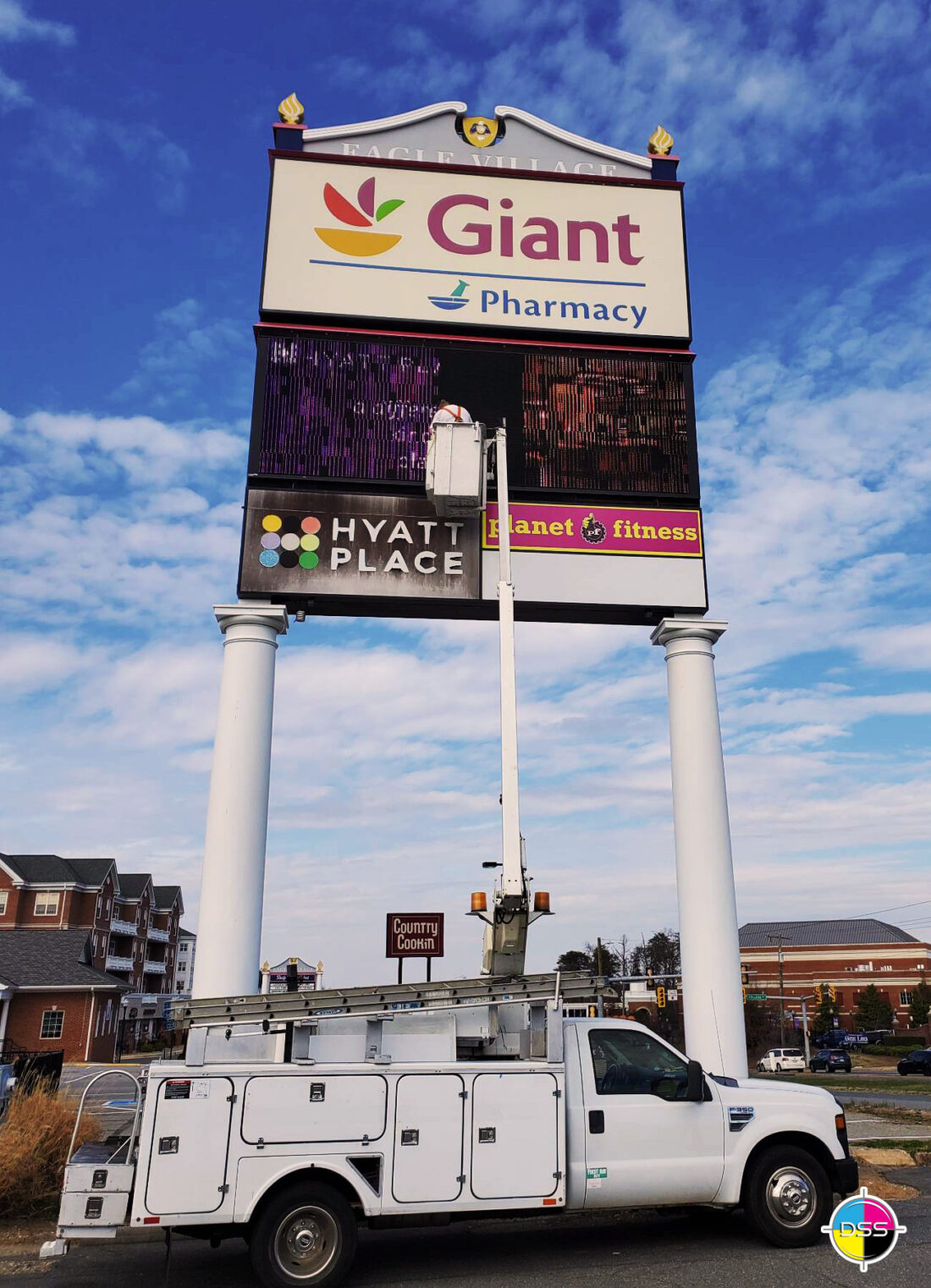 alt="Photo installer doing finishing touches on repair of electronic message center sign located in Spotsylvania, Virginia"