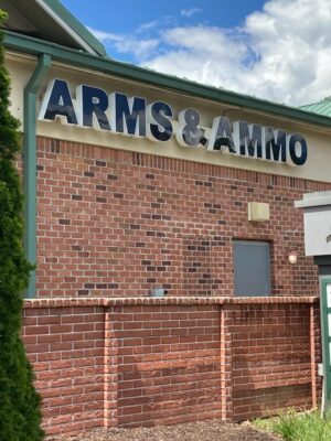 alt="Photo of black and white gun shop channel letter sign located in Stafford, Virginia"