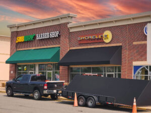 alt="Photo of black awning affixed to brick wall located in Harrison Crossing of Spotsylvania, Virginia"