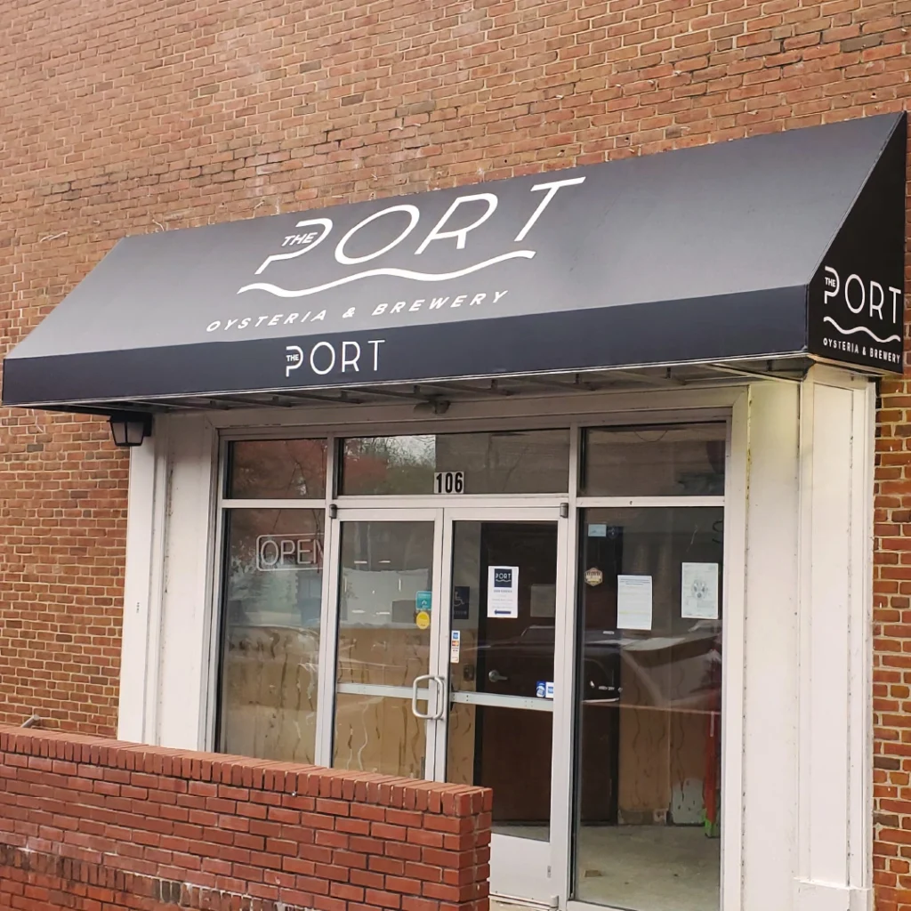 A business awning for The Port Oysteria and Brewery in downtown Fredericksburg, created by Distinct Sign Solutions.