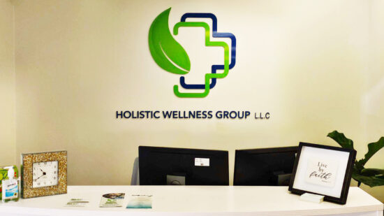 An acrylic wall sign for Holistic Wellness Group, created by Distinct Sign Solutions (DSS).