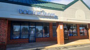 alt="Photo of Channel Letter sign for Doctor Floss with Tooth Logo mounted to EIFS wall located in Spotsylvania, Virgina"