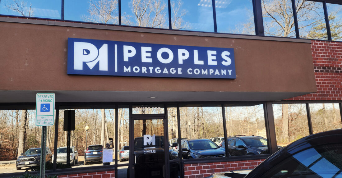 Professional building sign for People's Mortgage Company installed above the entrance of their office in Fredericksburg, VA, designed and crafted by Distinct Sign Solutions.