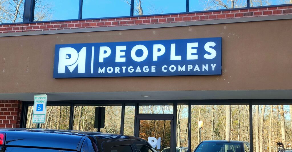 Professional building sign for People's Mortgage Company installed above the entrance of their office in Fredericksburg, VA, designed and crafted by Distinct Sign Solutions.