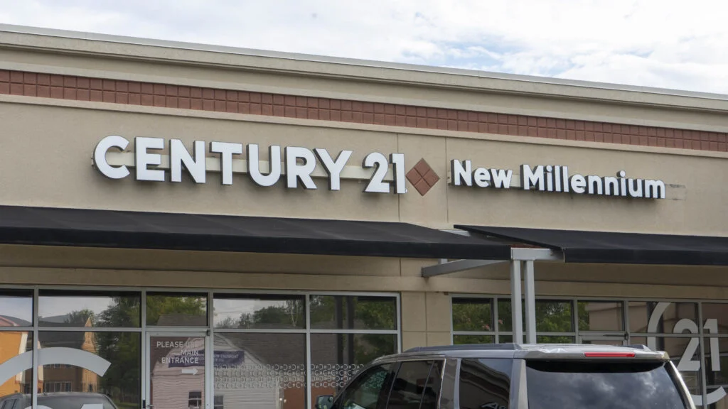 Elegant and modern channel letter sign for Century 21 New Millennium, crafted by Distinct Sign Solutions, displayed on the facade of their Fredericksburg, VA office.