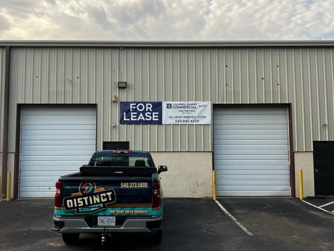 alt="Photo of Blue and White Coldwell Banker Elite For Lease Banner mounted to corrugated metal wall located in Spotsylvania, Virginia"