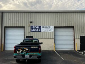 alt="Photo of Blue and White Coldwell Banker Elite For Lease Banner mounted to corrugated metal wall located in Spotsylvania, Virginia"