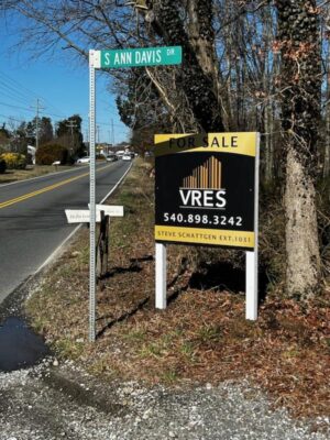 alt="Photo of black and gold For Sale sign along major roadway in Spotsylvania, Virginia "