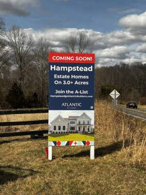 alt="Photo of Vibrant red and blue Atlantic Builders Coming Soon Home Builder sign located in Stafford, Virginia"