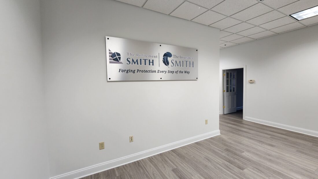 alt="Photo of Teal & White Logo Graphics mounted to brushed aluminum panel installed with black standoffs located in Fredericksburg, Virginia"