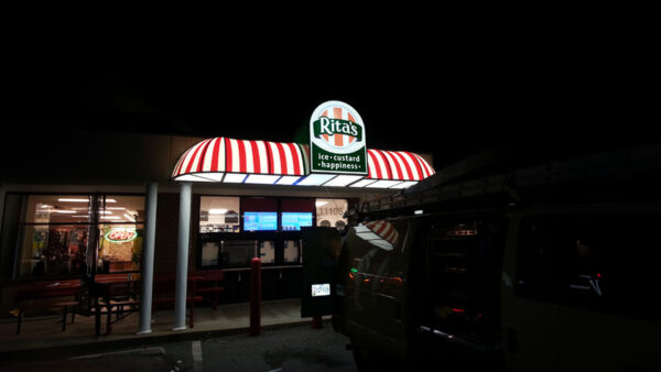 A red and white, illuminated awning for Rita’s Italian Ice & Frozen Custard, installed by Distinct Sign Solutions in Fredericksburg, VA. 