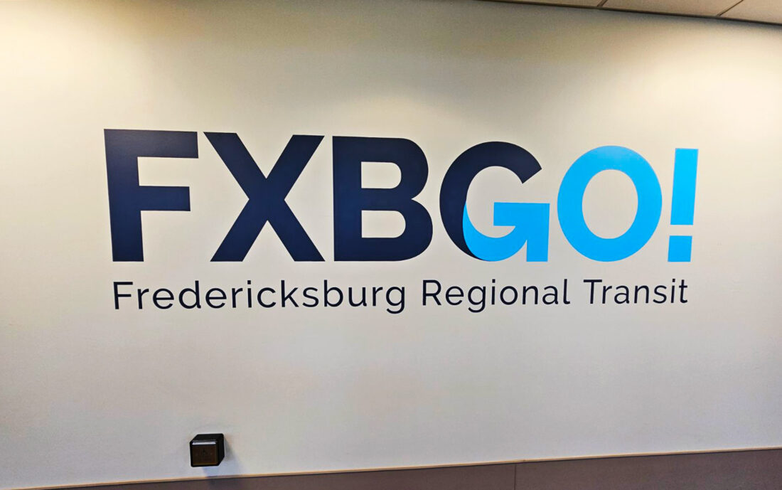 alt="Photo of Blue Flat Vinyl Graphic on standard drywall that says FXBGO! Fredericksburg Regional Transit located in Fredericksburg, Virginia"