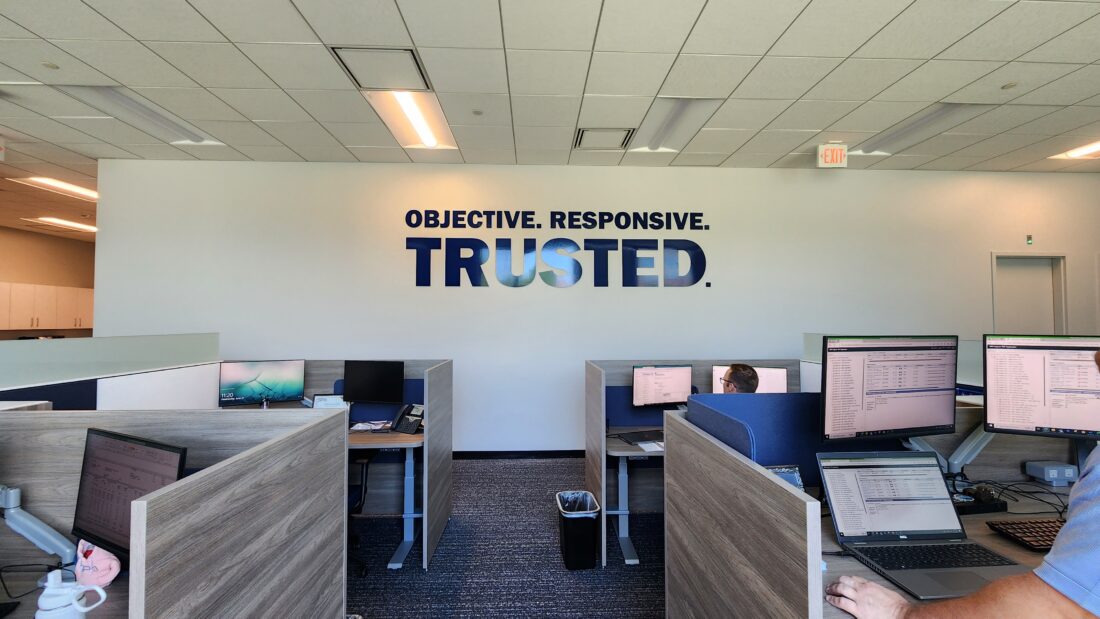 alt="Inner Office Wall with 3D Dark Blue Acrylic wall sign saying Objective. Responsive. Trusted. in Washington, DC"