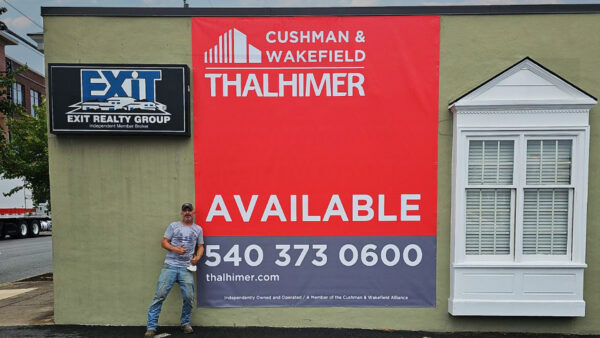 Large red and gray 'Available' banner for Cushman & Wakefield | Thalhimer created using wide format print by Distinct Signs in Fredericksburg, VA.