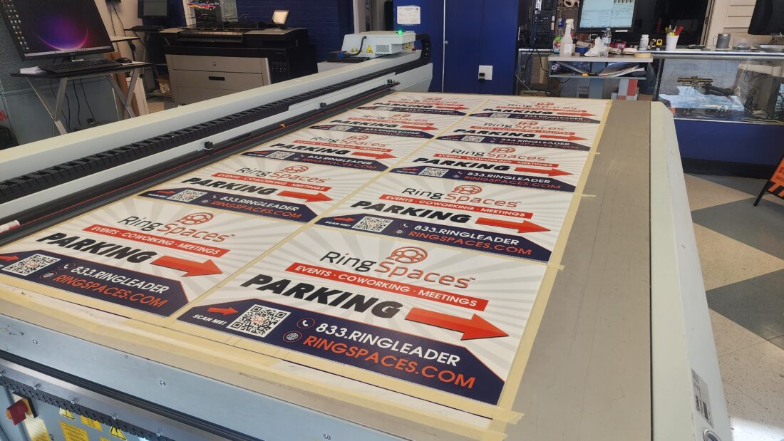 Photo of newly printed yard signs on flatbed printer in Fredericksburg, VA. Signs were manufactured by Distinct Sign Solutions in Fredericksburg, VA