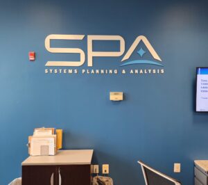 Photo of white and blue acrylic wall sign set on lobby wall in Lorton, VA. Sign was manufactured & installed by Distinct Sign Solutions in Fredericksburg, VA