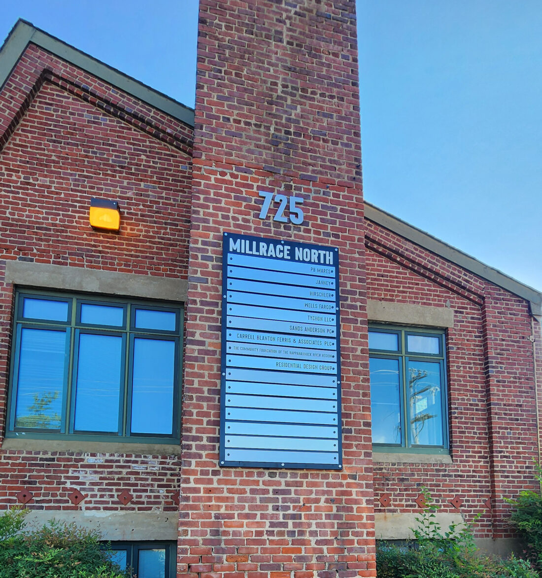 Picture of brick building with brushed aluminum directories & address numbers. Building is located in Fredericksburg, VA. Sign was manufactured & installed by Distinct Sign Solutions in Fredericksburg, VA.