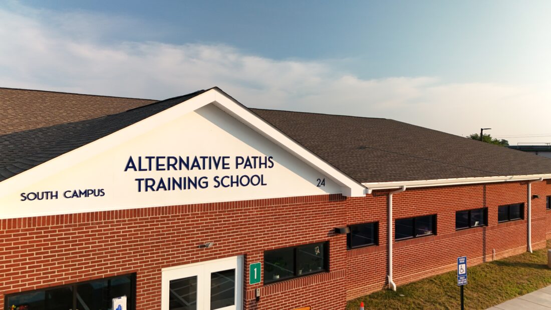 Drone shot of blue acrylic sign affixed to facade on school in Stafford, VA. Sign was manufactured & installed by Distinct Sign Solutions in Fredericksburg, VA