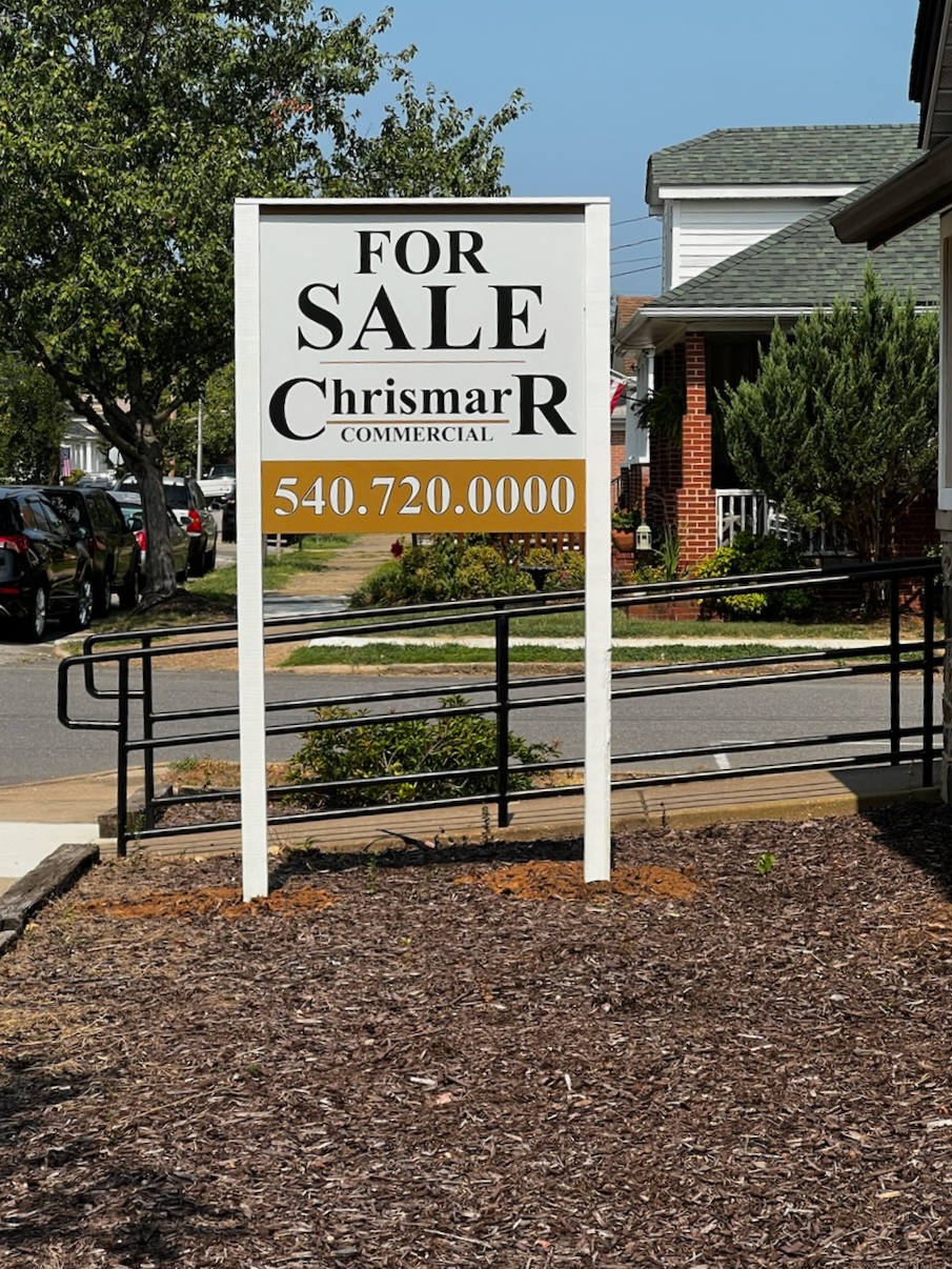 Photo of Chrismarr Realty For Sale Post and Panel sign set in mulch bed on property in Fredericksburg, VA. Sign was manufactured & installed by Distinct Sign Solutions in Fredericksburg, VA