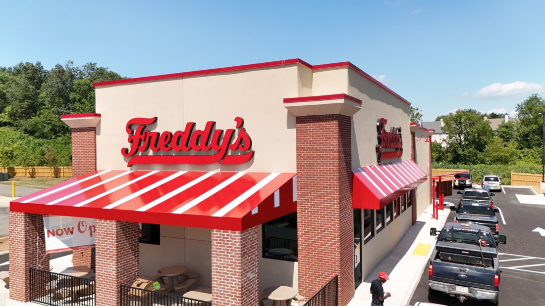 Drone shot of several red & white striped awnings for Freddy's in Manassas, VA. Awnings were manufactured & installed by Distinct Sign Solutions in Fredericksburg, VA