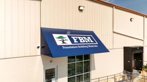 Photo of dark blue awning with FBM logo graphic in Spotsylvania, VA. Awning was manufactured & installed by Distinct Sign Solutions in Fredericksburg, VA