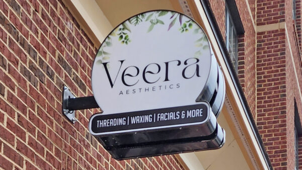 A downtown sign created by Distinct Signs for Veera Aesthetics. A blade sign.