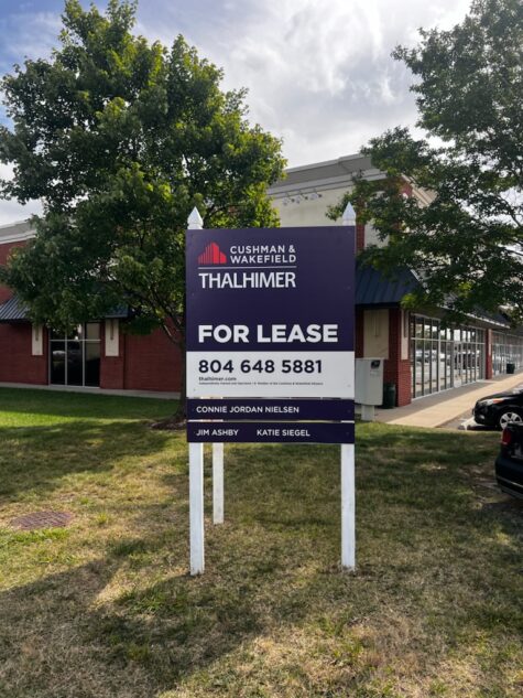 Photo of For Lease Post and Panel sign in grassy median in Fredericksburg, VA. Sign was manufactured & installed by Distinct Sign Solutions in Fredericksburg, VA