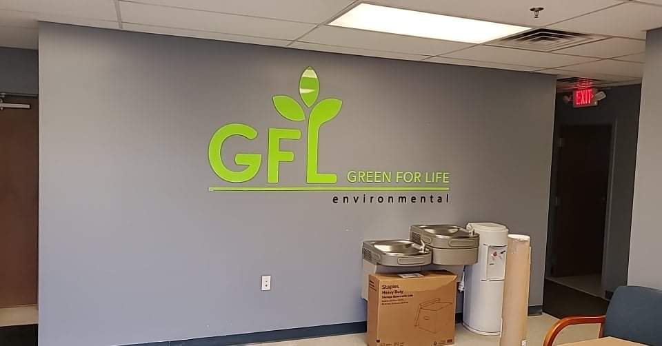 Photo of lime green acrylic wall sign mounted to drywall in Spotsylvania, VA. Sign was manufactured & installed by Distinct Sign Solutions in Fredericksburg, VA.