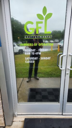 Photo of lime green vinyl graphic sign mounted to door in Spotsylvania, VA. Sign was manufactured & installed by Distinct Sign Solutions in Fredericksburg, VA.