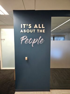 Photo of acrylic & vinyl wall sign for Peoples Mortgage in Fairfax, VA. Sign was manufactured & installed by Distinct Sign Solutions in Fredericksburg, VA