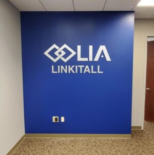 Photo of brushed aluminum metal on acrylic receptionist wall sign in Fredericksburg, VA. Sign was manufactured & installed by Distinct Sign Solutions in Fredericksburg, VA