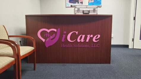 Photo of acrylic logo sign affixed to wooden desk in Stafford, VA. Sign was manufactured & installed by Distinct Sign Solutions in Fredericksburg, VA