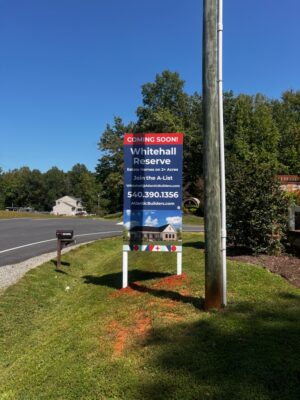 Photo of large vertical post & panel sign in grassy area at entrance of new housing development. Sign is located in Spotsylvania, VA and was manufactured & installed by Distinct Sign Solutions in Fredericksburg, VA.