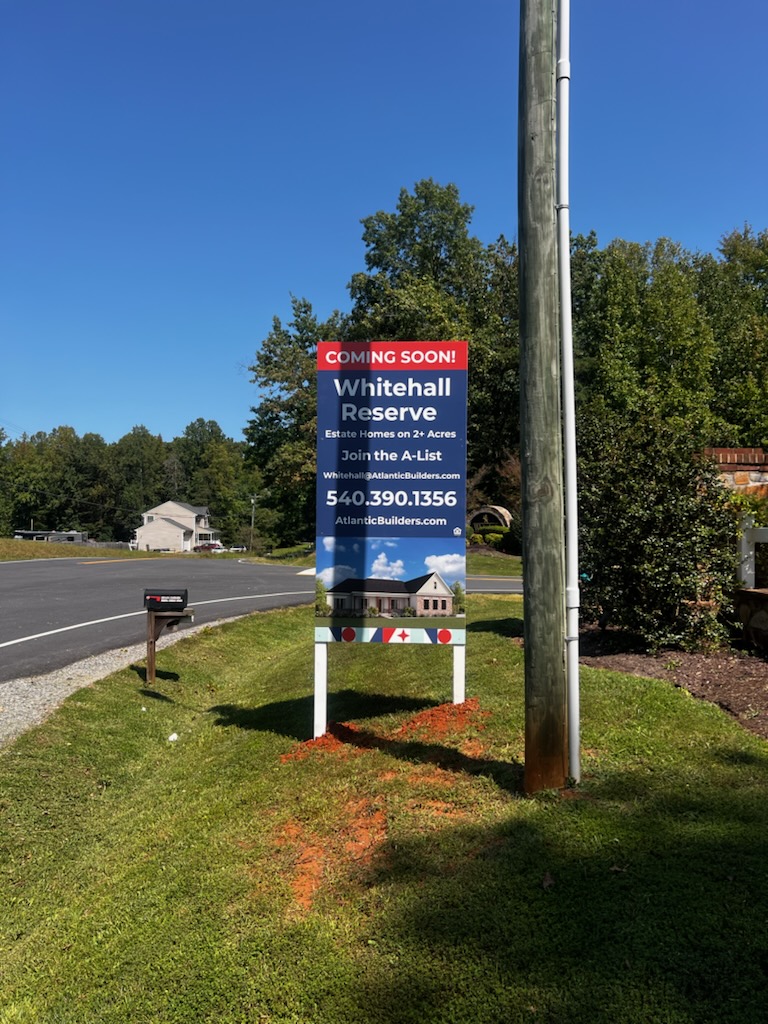 Photo of large vertical post & panel sign in grassy area at entrance of new housing development. Sign is located in Spotsylvania, VA and was manufactured & installed by Distinct Sign Solutions in Fredericksburg, VA.