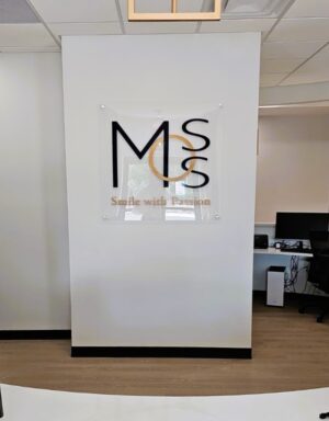 Photo of blue & gold wall sign set on a drywall receptionist wall located in Fredericksburg, VA. Sign was manufactured & installed by Distinct Sign Solutions of Fredericksburg, VA