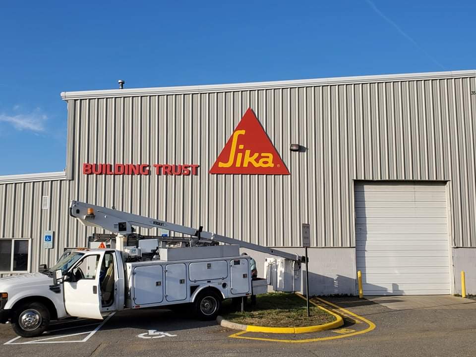 Custom Acrylic & Aluminum Wall Sign affixed to corrugated metal wall in Stafford, VA. Sign was manufactured & installed by Distinct Sign Solutions in Fredericksburg, VA