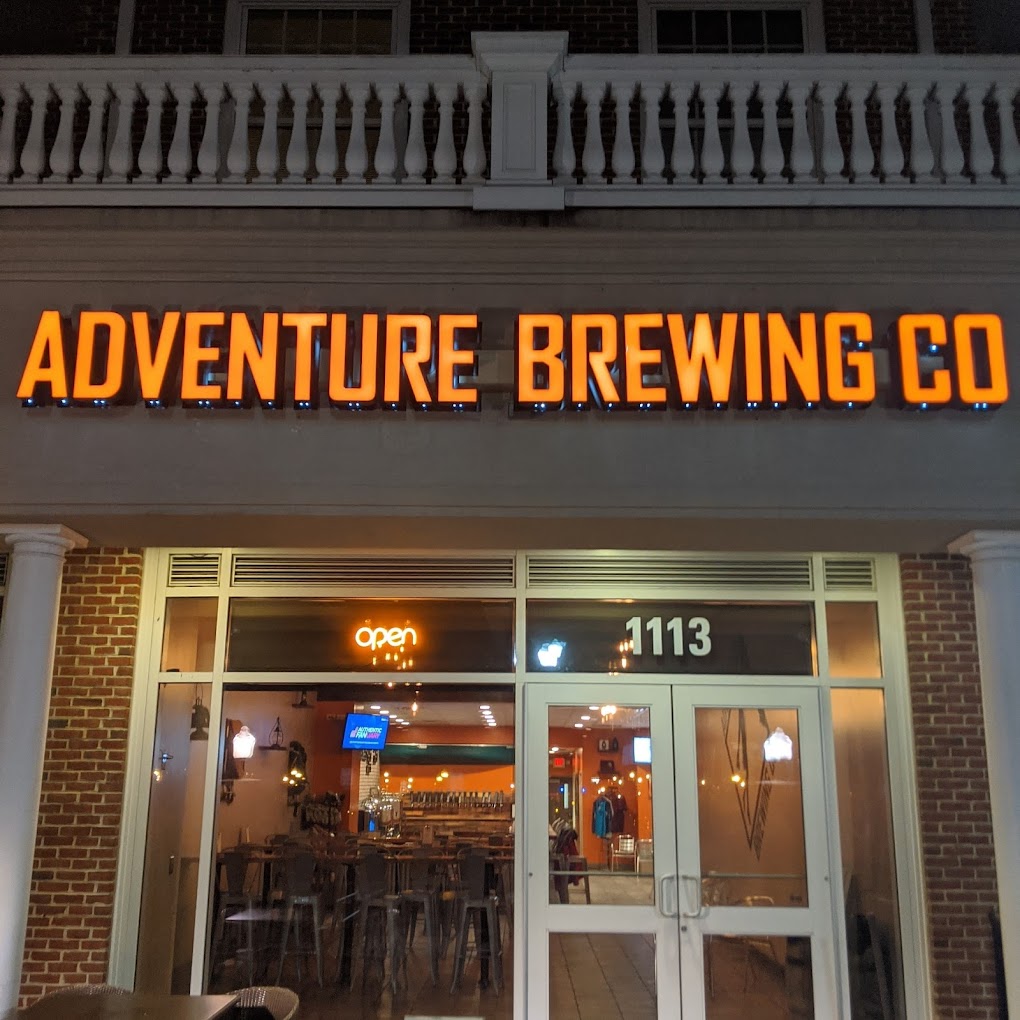 Nighttime photo of Adventure Brewing Co Channel letter sign, located in Fredericksburg, VA. Sign was manufactured & installed by Distinct Sign Solutions in Fredericksburg, VA